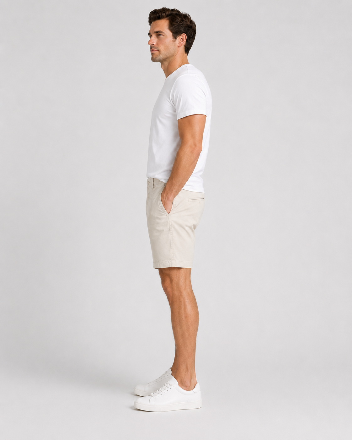 Men's white chino shorts styled with white crew neck t-shirt and sneakers
