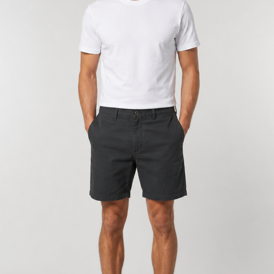 Men's black chino shorts paired with white t-shirt and white sneakers
