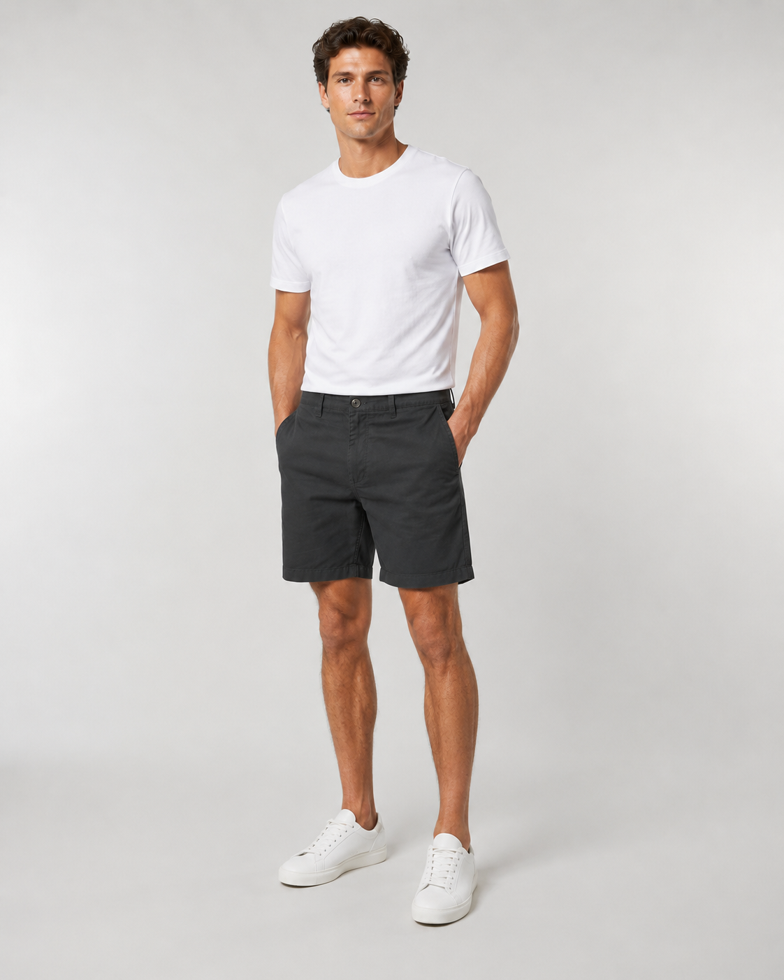Men's black chino shorts paired with white t-shirt and white sneakers
