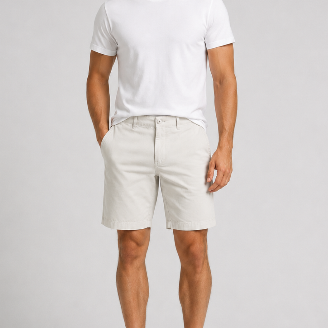 Men's white chino shorts styled with white crew neck t-shirt and sneakers