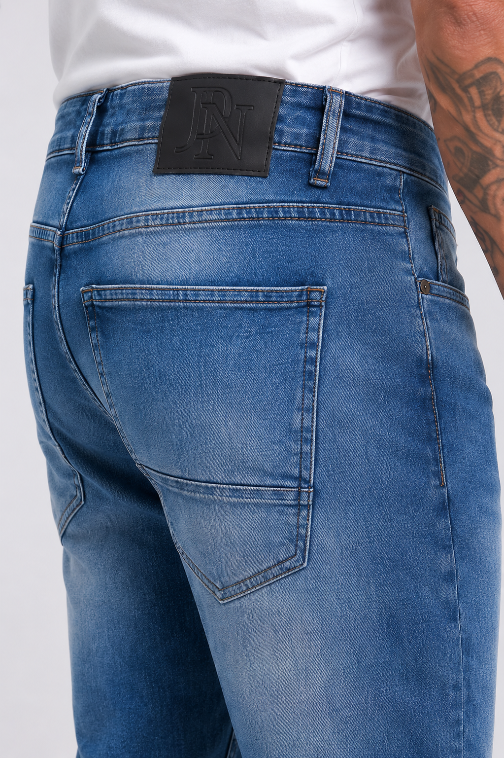 Men's JDN branded slim fit jeans in light wash blue denim with tapered leg and classic five-pocket design