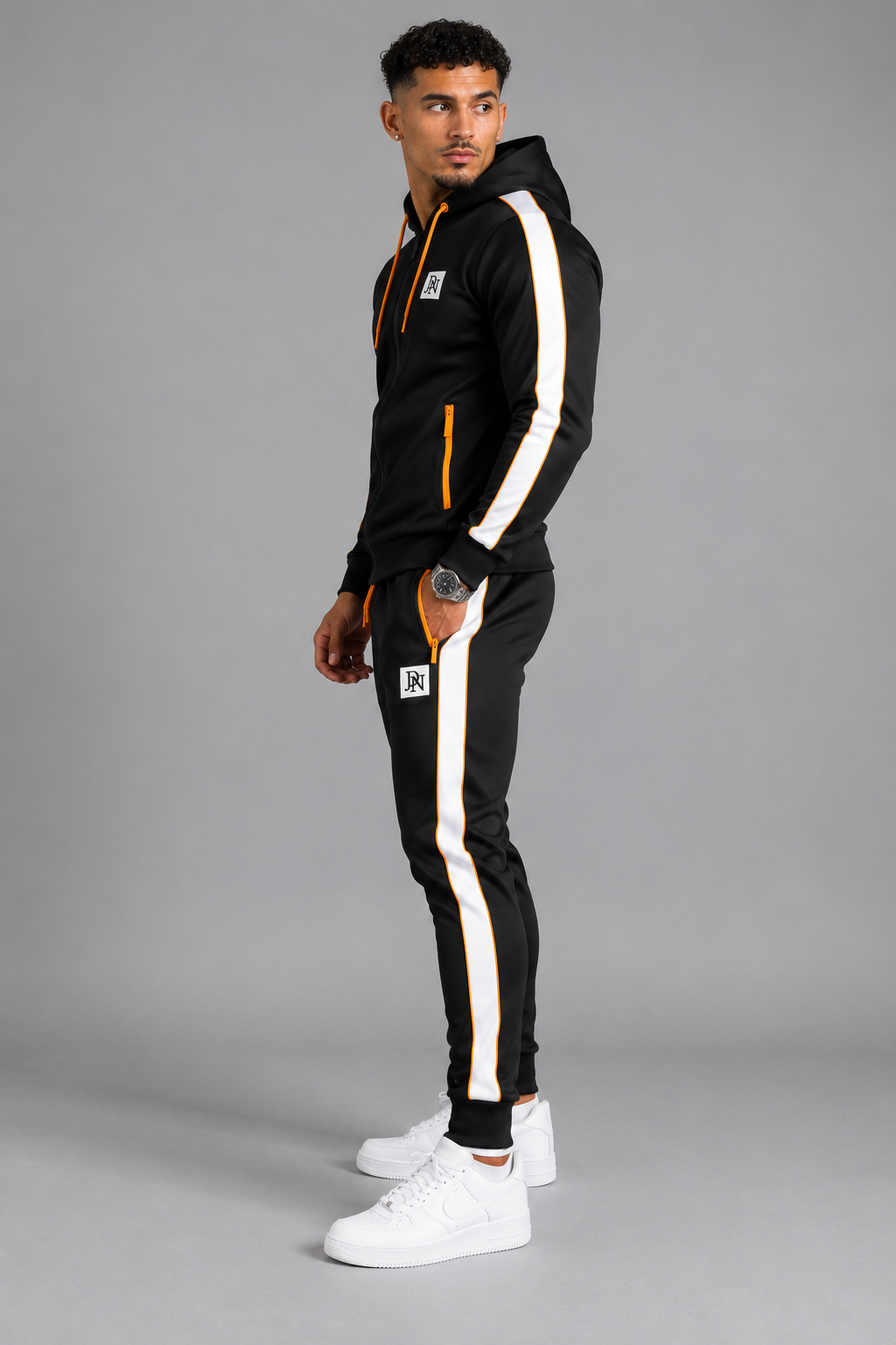 Men's JDN black tracksuit set with orange zip details and white side stripes – full zip hoodie and joggers, sporty streetwear style