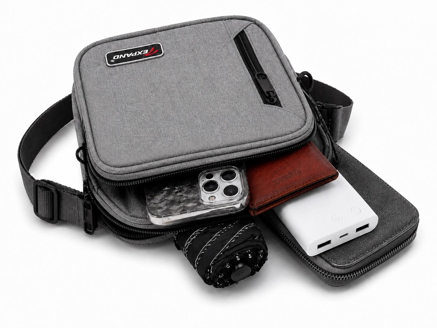 Grey men’s crossbody bag with adjustable shoulder strap, multiple zipped compartments and a compact design, ideal for everyday use, travel and keeping essentials organised.