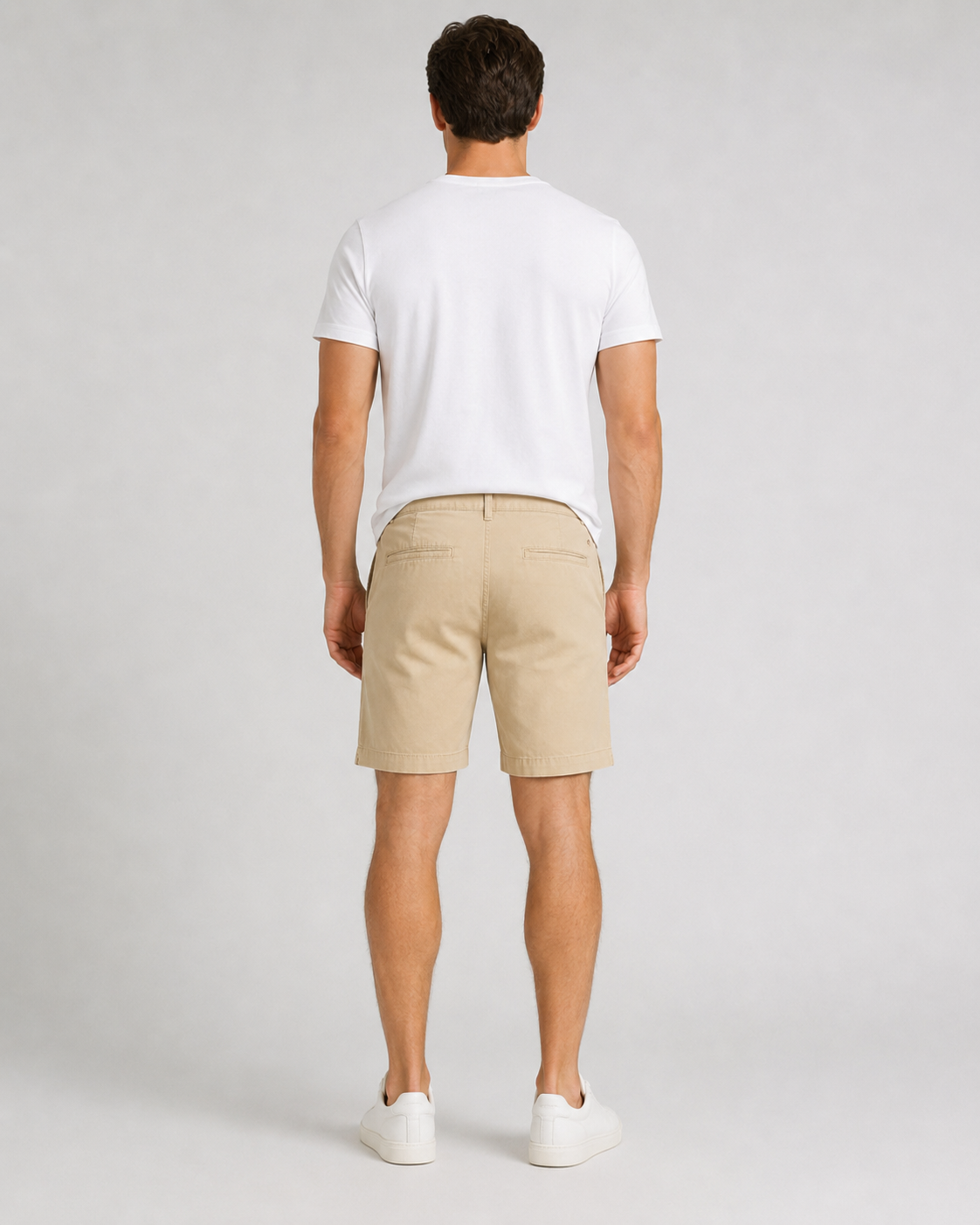 Men's beige chino shorts with white crew neck t-shirt and white sneakers