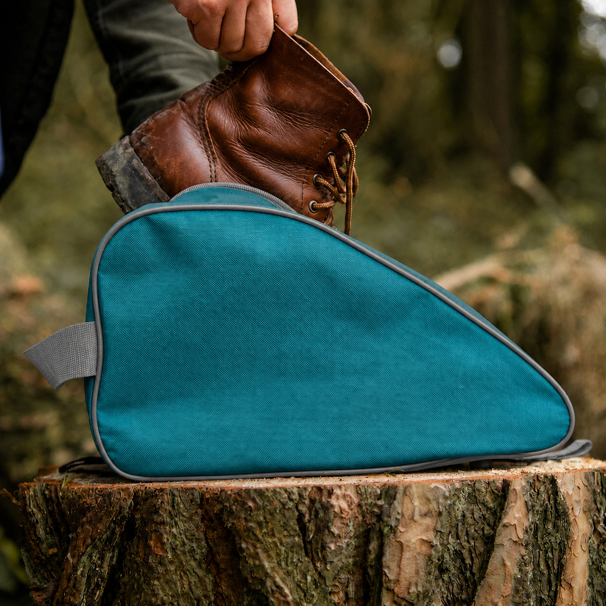 Teal waterproof boot bag with a curved zip opening and durable fabric finish