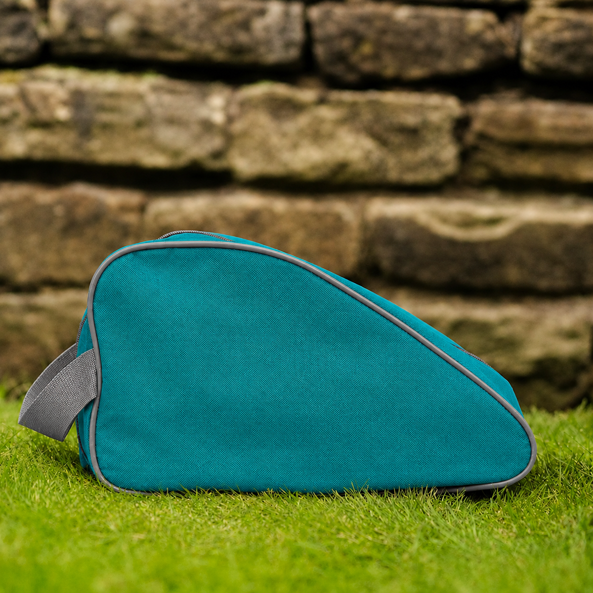 Teal waterproof boot bag with a curved zip opening and durable fabric finish