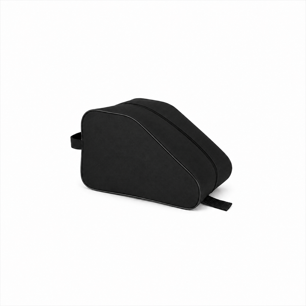 Black waterproof boot bag beside a tree stump as a brown walking boot is placed inside, ideal for outdoor footwear storage