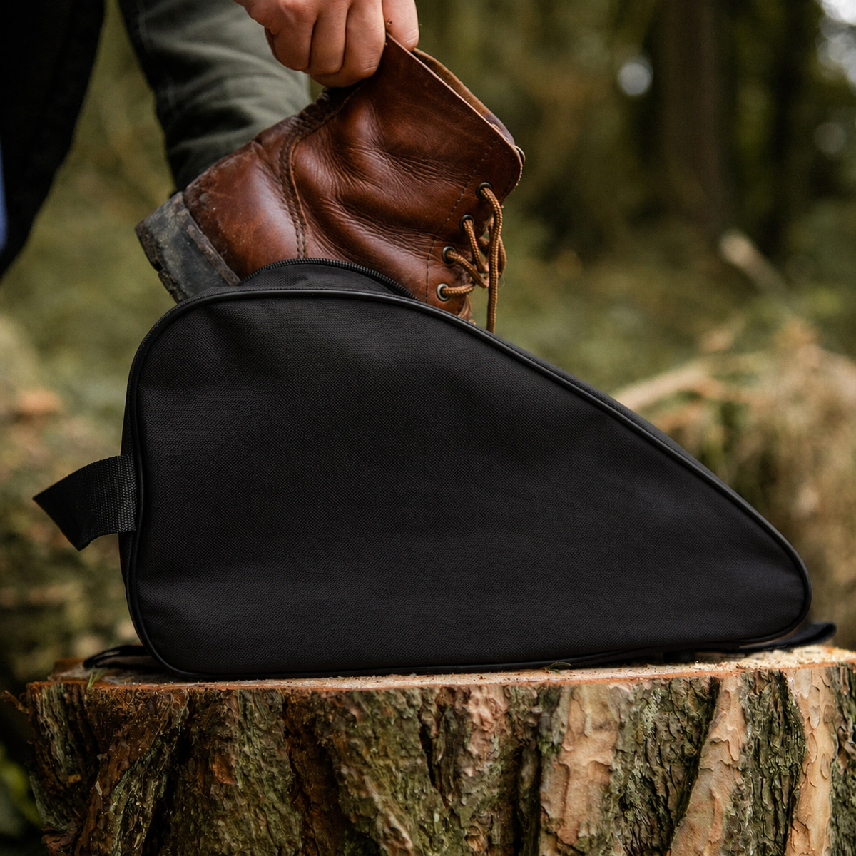 Black waterproof boot bag with a curved zip opening and durable fabric finish
