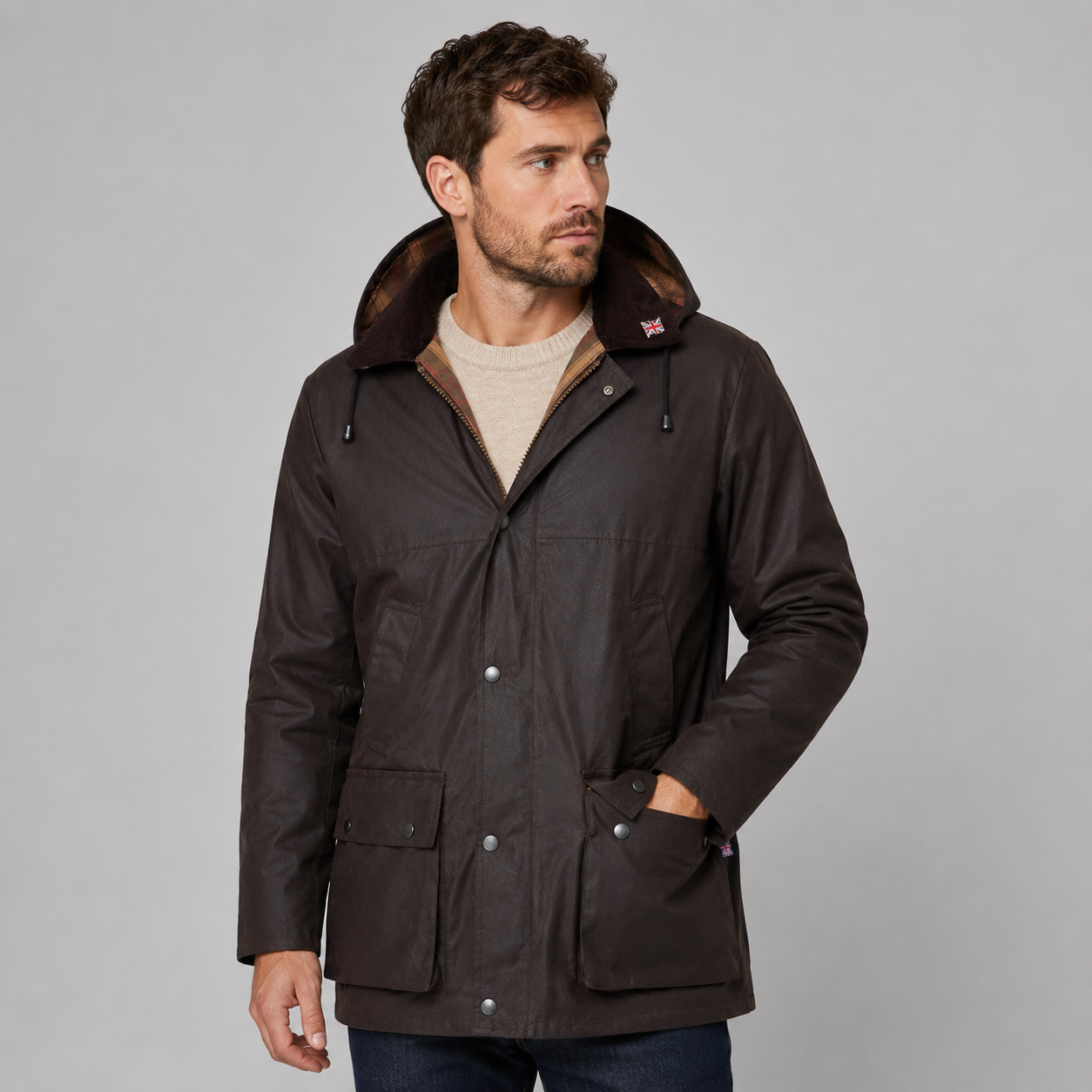 Shop the Nicky Adams 100% Waterproof Wax Jacket featuring a classic British design, checked lining, corduroy collar, adjustable hood, and durable all-weather protection