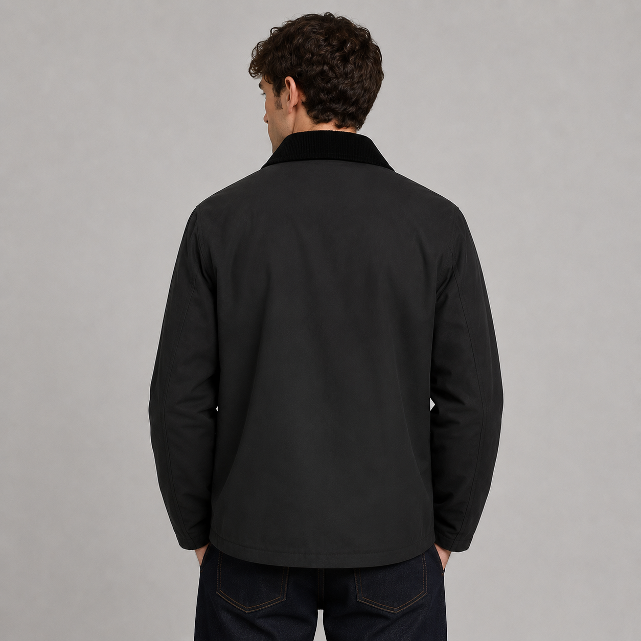 Men’s 100% waterproof unpadded wax jacket by Nicky Adams, featuring lightweight all-season protection, heritage-inspired styling, utility pockets, and a classic cord collar. Styled on a male model against a clean studio background, this versatile waxed jacket is ideal for smart casual, outdoor, and everyday wear.