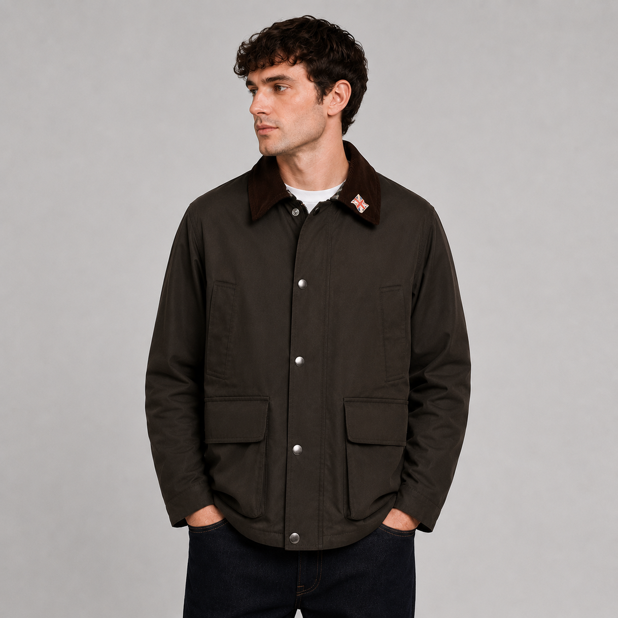 Men’s 100% waterproof unpadded wax jacket by Nicky Adams, featuring lightweight all-season protection, heritage-inspired styling, utility pockets, and a classic cord collar. Styled on a male model against a clean studio background, this versatile waxed jacket is ideal for smart casual, outdoor, and everyday wear.