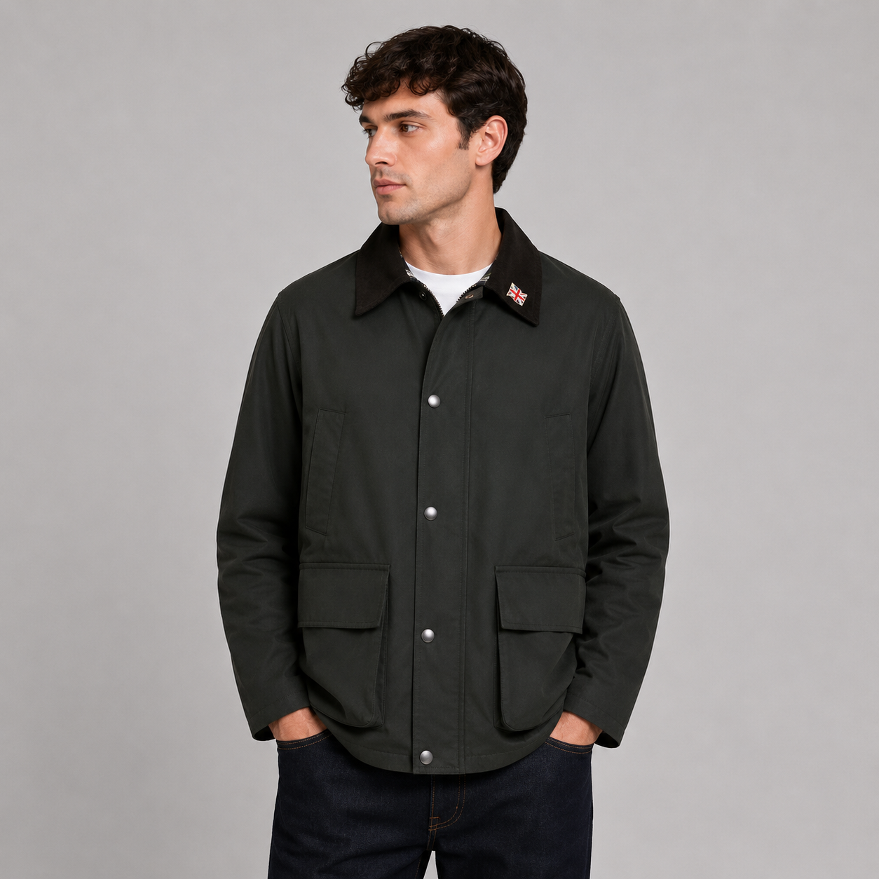 Men’s 100% waterproof unpadded wax jacket by Nicky Adams, featuring lightweight all-season protection, heritage-inspired styling, utility pockets, and a classic cord collar. Styled on a male model against a clean studio background, this versatile waxed jacket is ideal for smart casual, outdoor, and everyday wear.