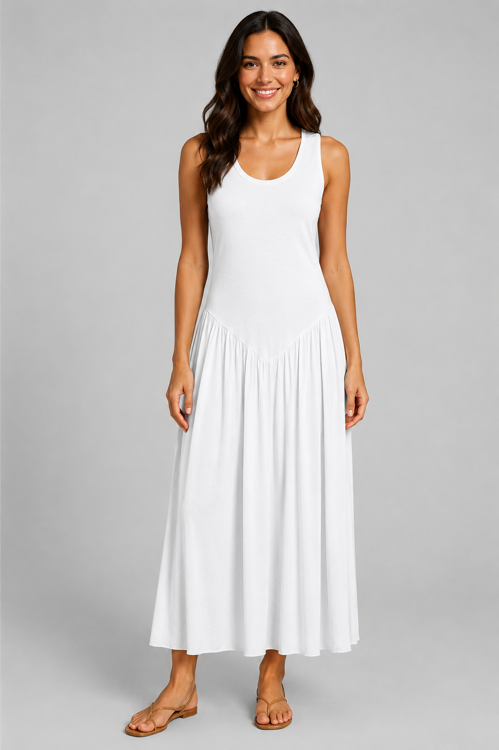 Women's sleeveless maxi dress featuring a scoop neckline, fitted bodice, and flowing gathered skirt. Shown in a soft brown jersey fabric with a relaxed silhouette and maxi length, styled on a model against a light grey studio background.