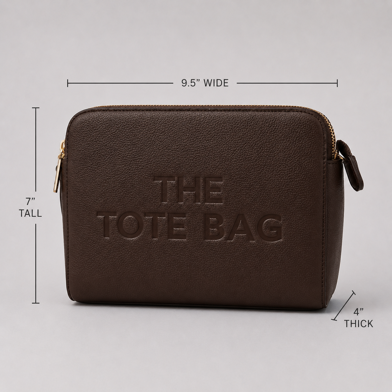 The Tote Bag crossbody bag with adjustable branded strap and gold hardware.