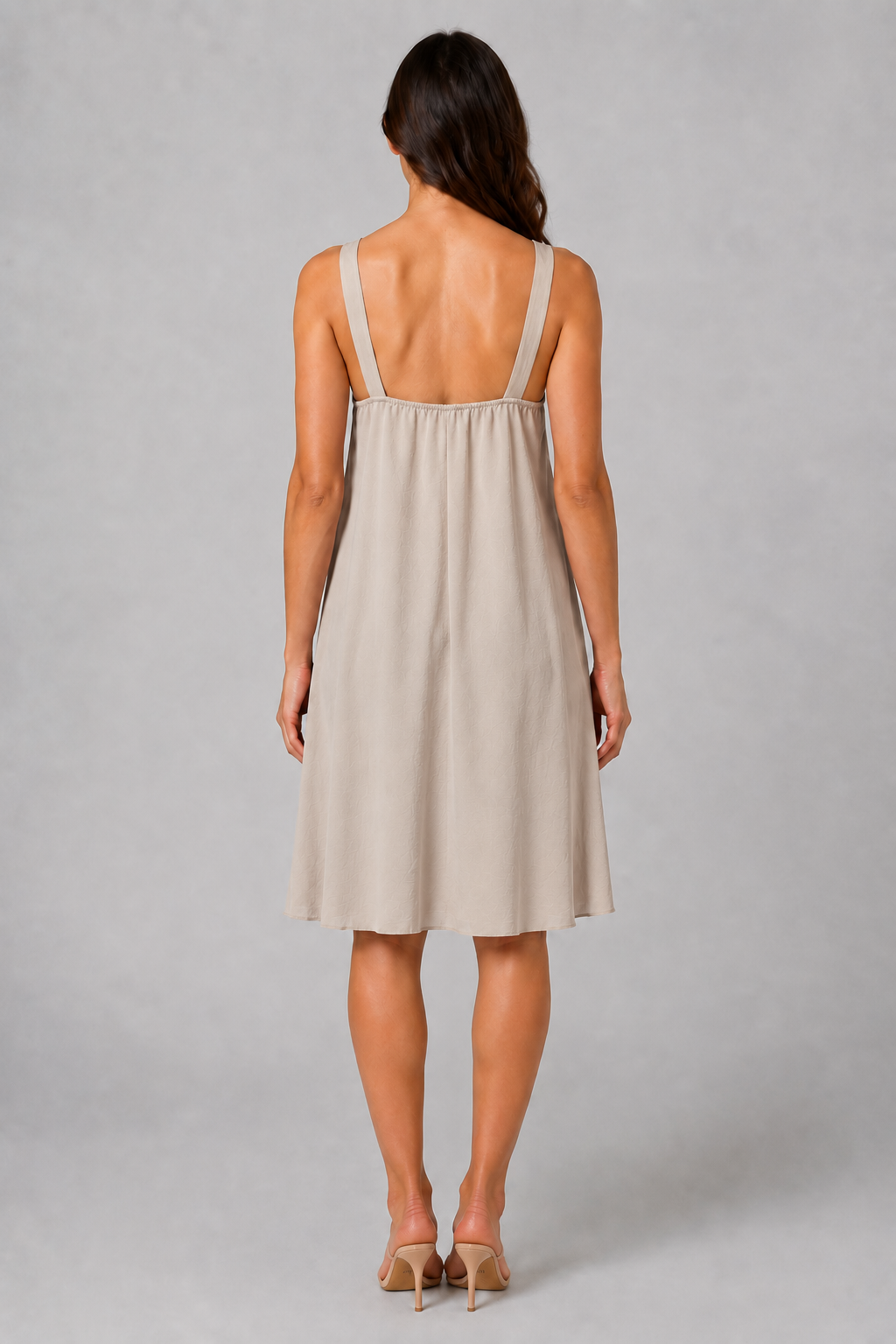 Beige sleeveless knee-length swing dress with a scoop neckline, subtle tonal texture and gold-tone chain-link shoulder details.