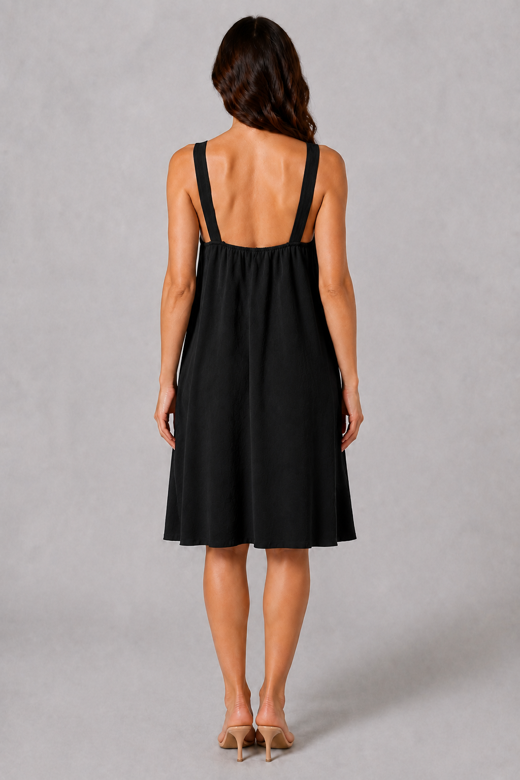 Black sleeveless knee-length swing dress with a scoop neckline, subtle tonal texture and gold-tone chain-link shoulder details.