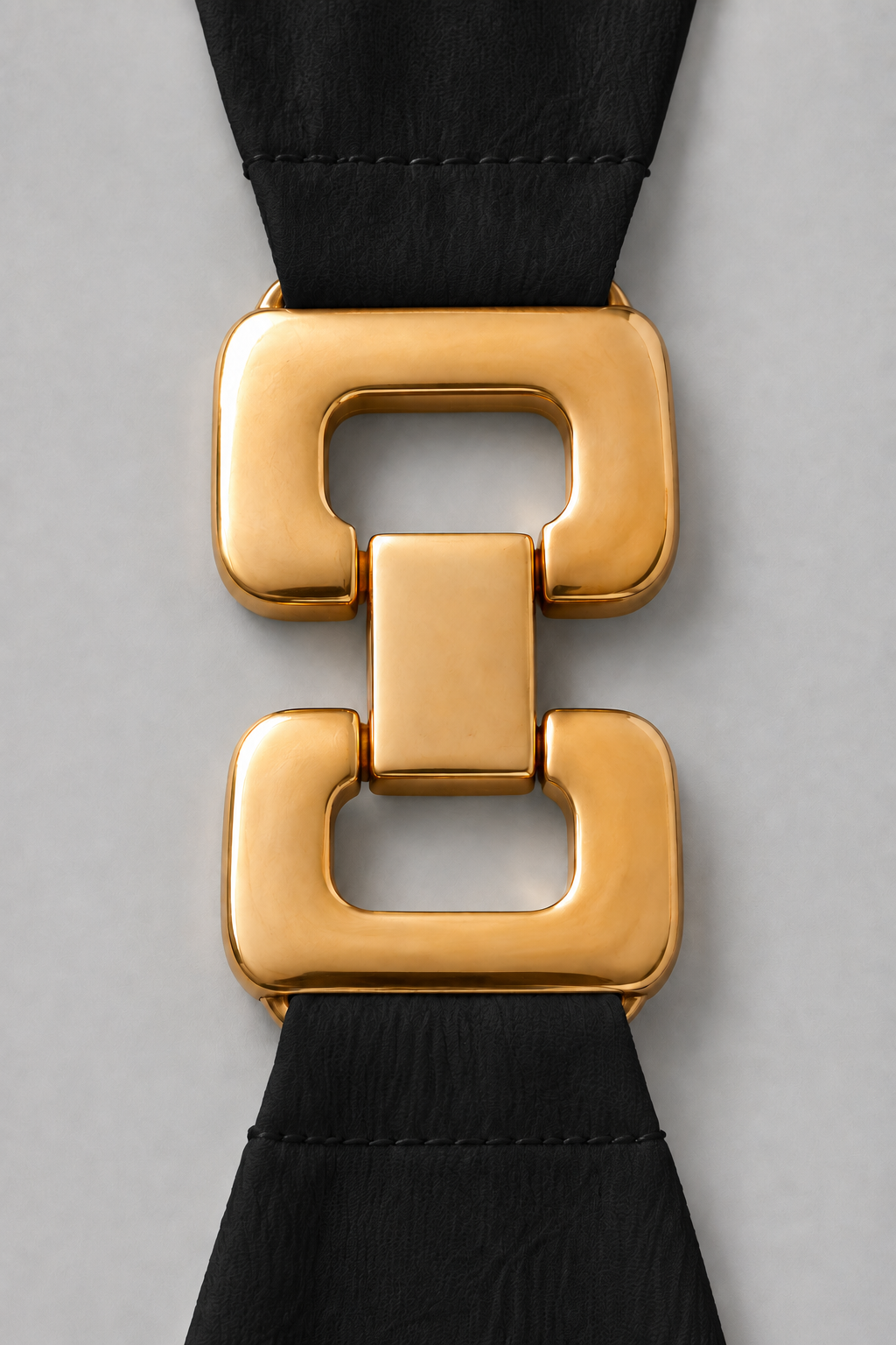 Black sleeveless knee-length swing dress with a scoop neckline, subtle tonal texture and gold-tone chain-link shoulder details.