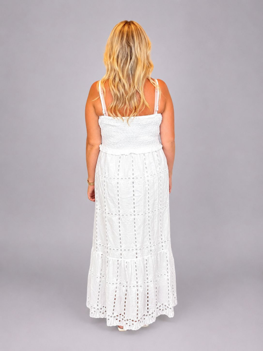 Women's white broderie anglaise maxi dress with a shirred bodice, tiered skirt and embroidered eyelet detailing, perfect for summer holidays and special occasions.