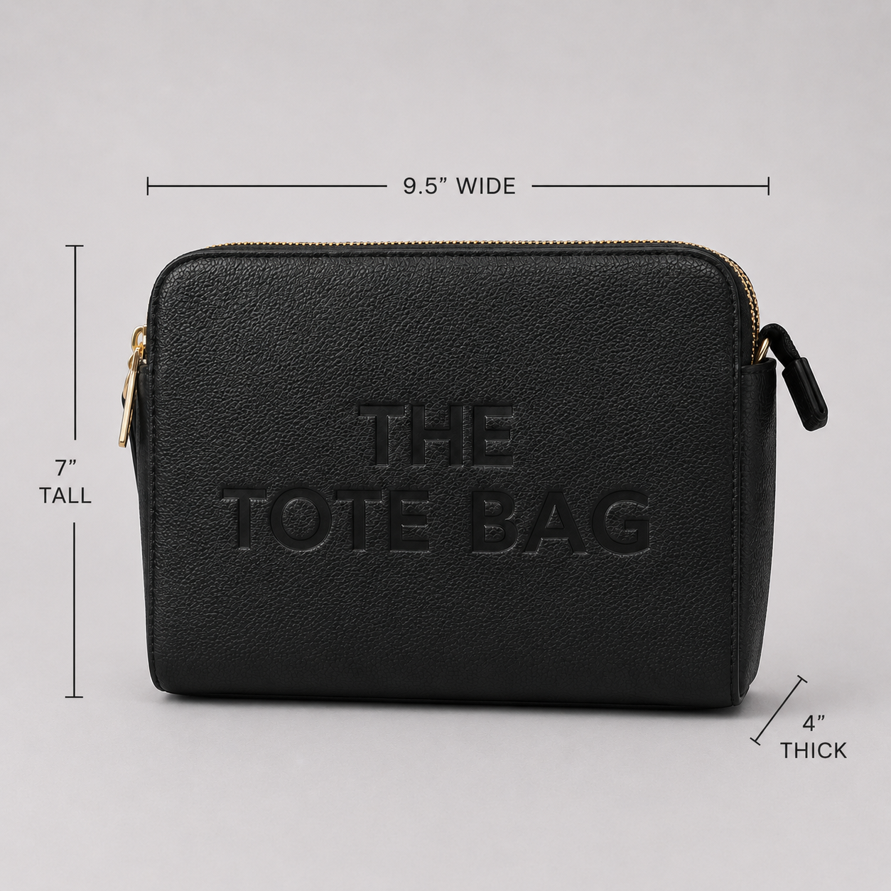 The Tote Bag crossbody bag with adjustable branded strap and gold hardware.