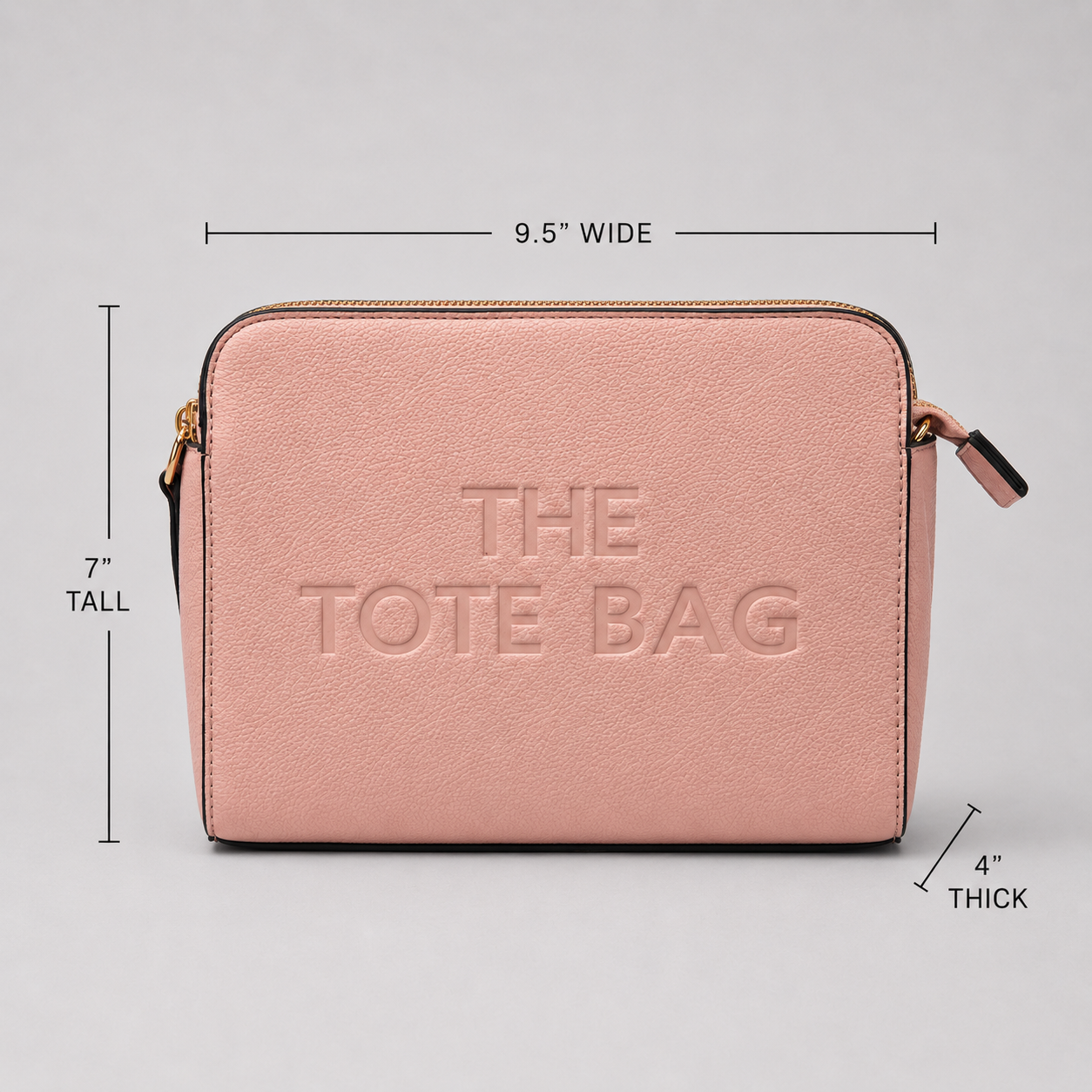 The Tote Bag crossbody bag with adjustable branded strap and gold hardware.