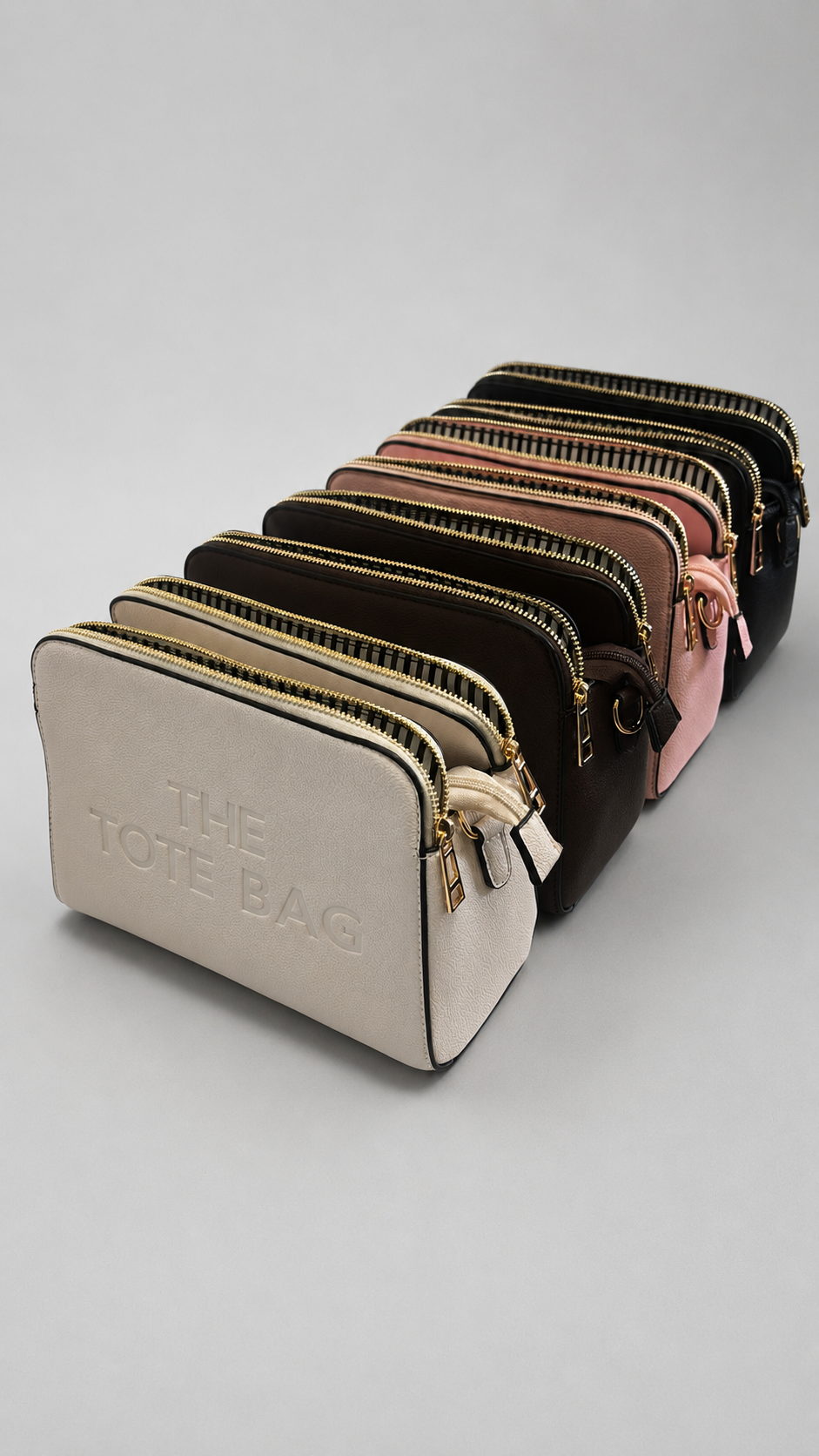 The Tote Bag crossbody bag with adjustable branded strap and gold hardware.