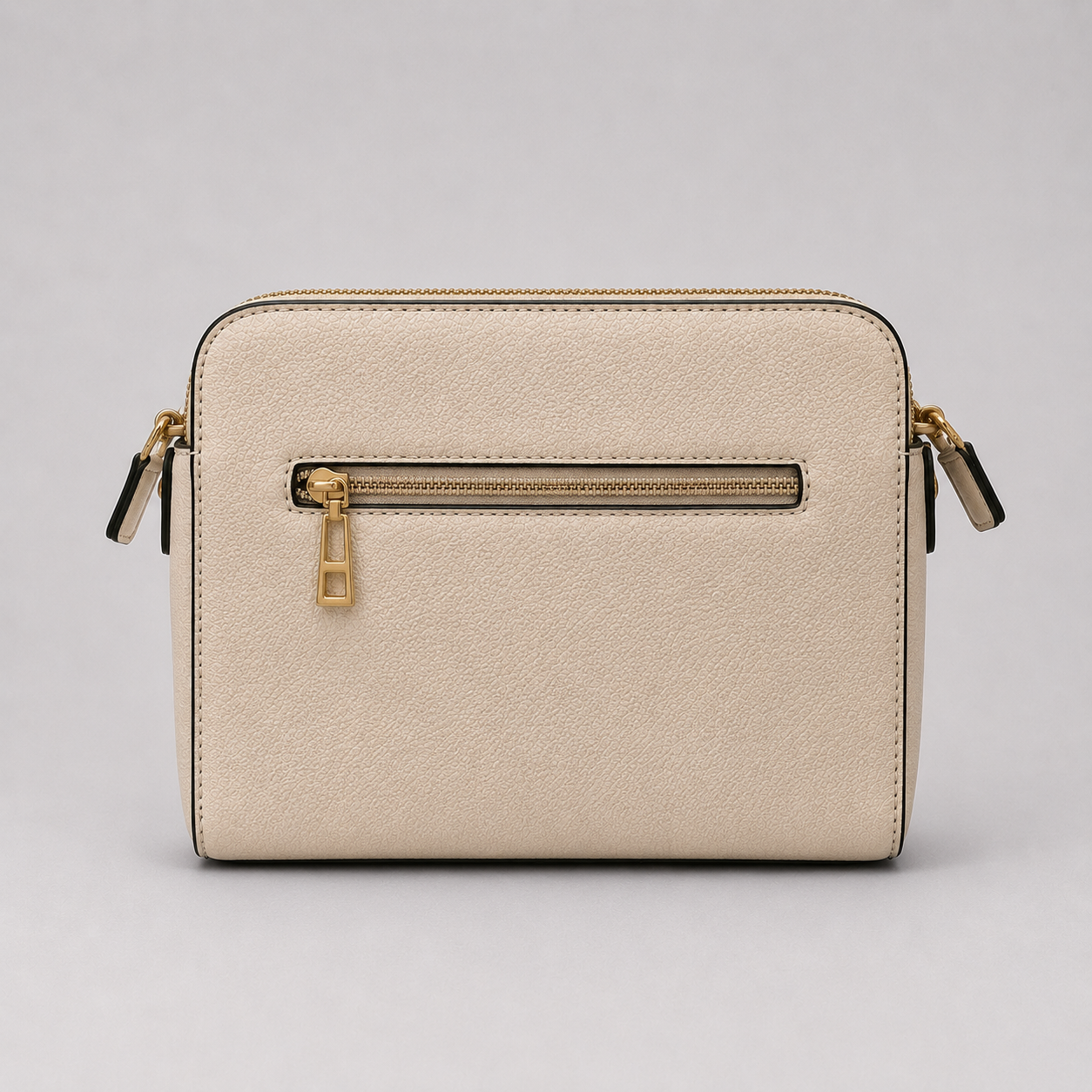 The Tote Bag crossbody bag with adjustable branded strap and gold hardware.