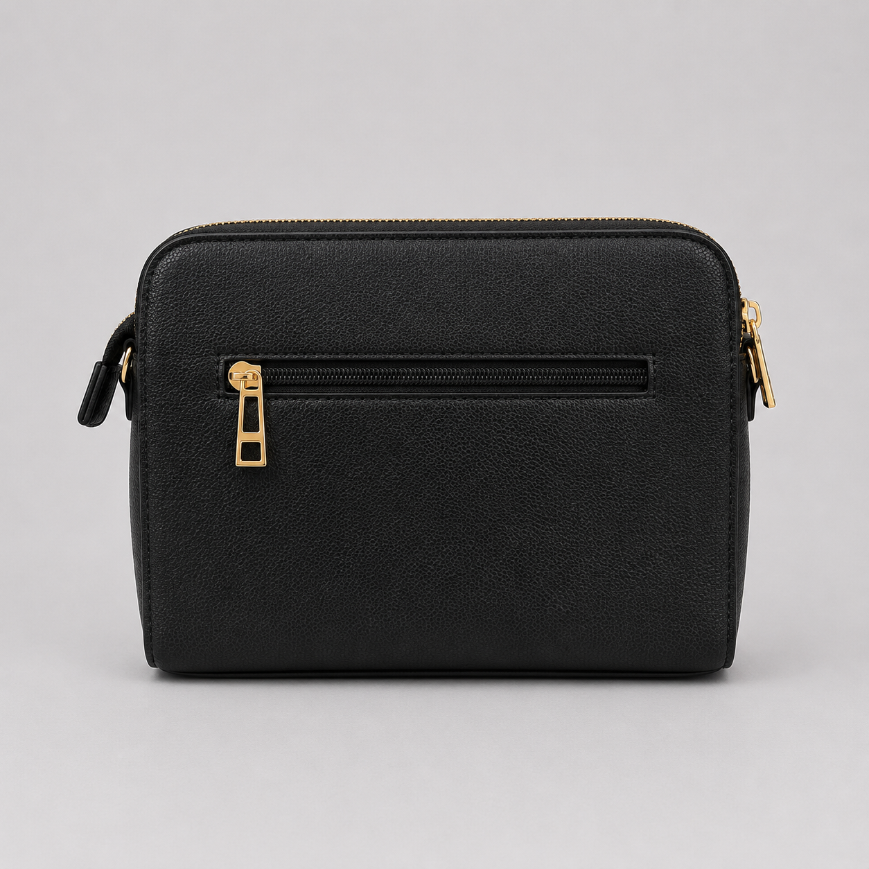 The Tote Bag crossbody bag with adjustable branded strap and gold hardware.