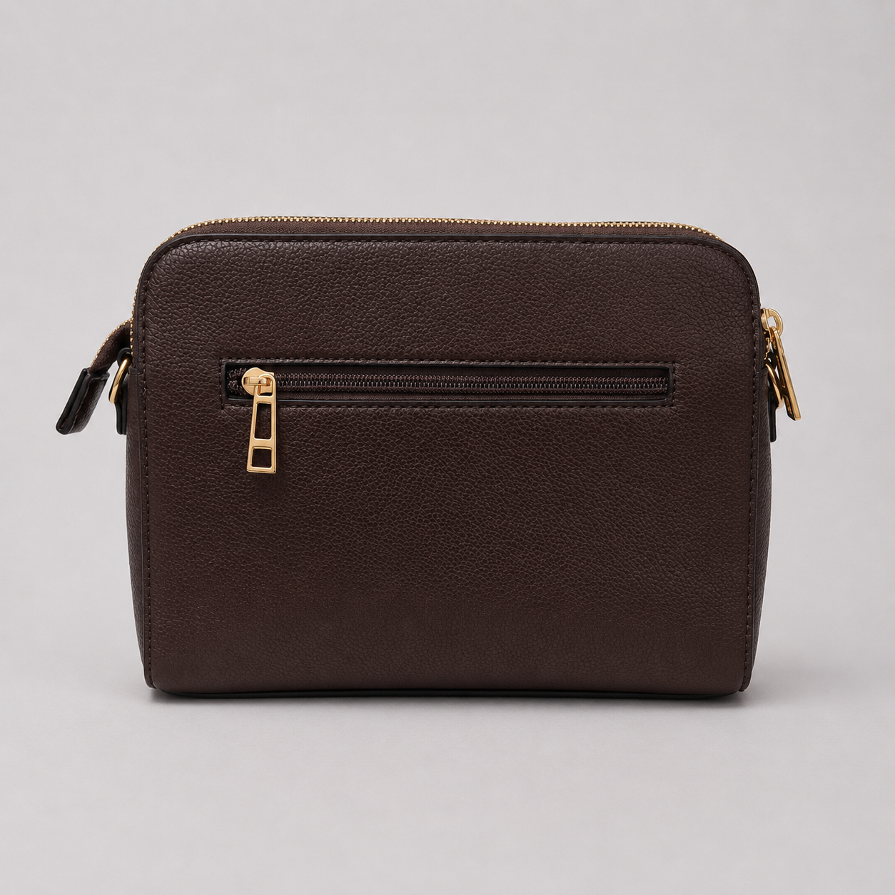 The Tote Bag crossbody bag with adjustable branded strap and gold hardware.