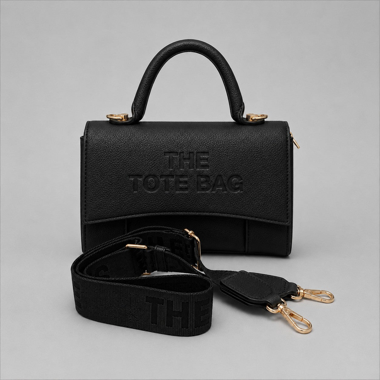 Ladies Tote Bag in Black. A stylish structured handbag with top handle, detachable shoulder strap, gold-tone hardware and designer-inspired detailing.