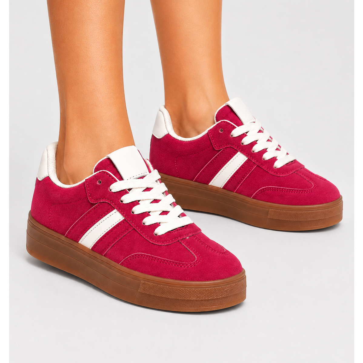 Women's pink chunky platform sneakers with white side stripes, lace-up fastening, gum sole and retro-inspired casual styling.