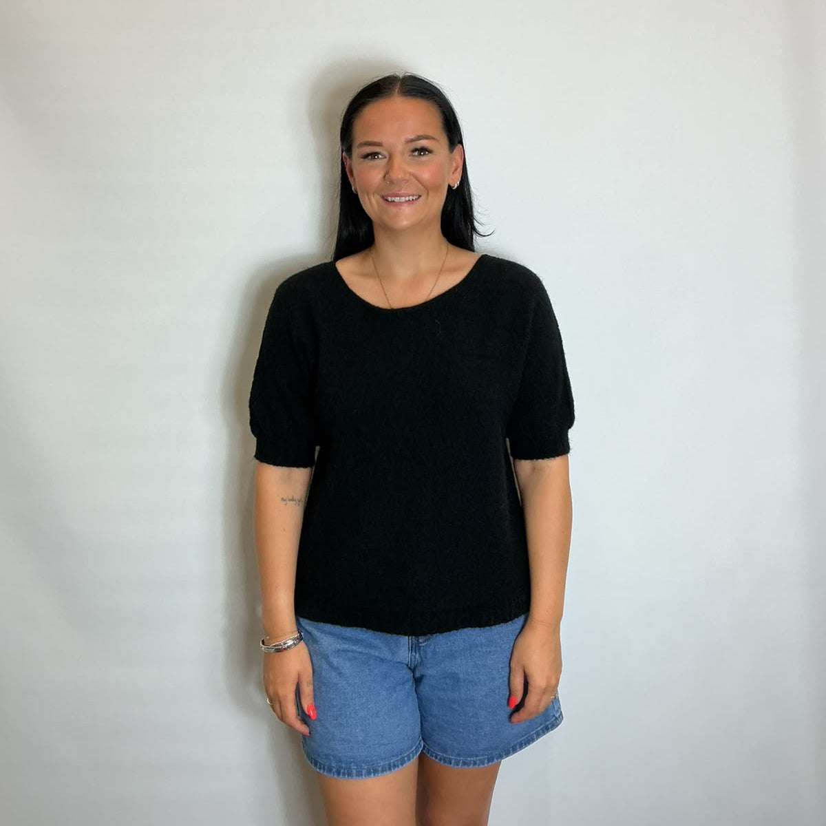 Women’s Black short-sleeve relaxed knit jumper with a wide round neckline and ribbed cuffs and hem.