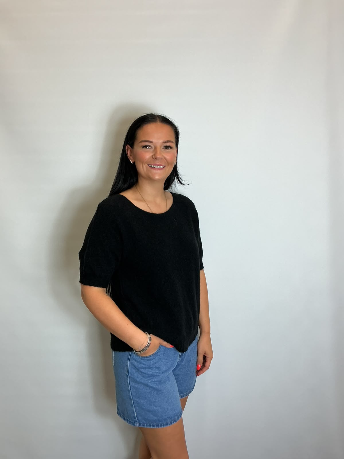 Women’s Black short-sleeve relaxed knit jumper with a wide round neckline and ribbed cuffs and hem.
