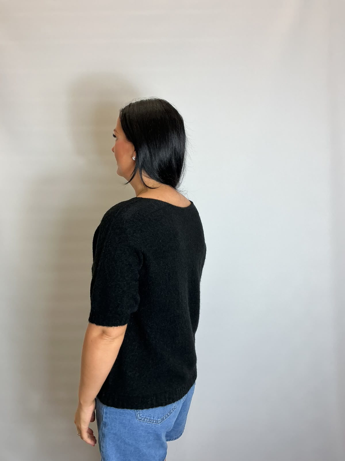 Women’s Black short-sleeve relaxed knit jumper with a wide round neckline and ribbed cuffs and hem.