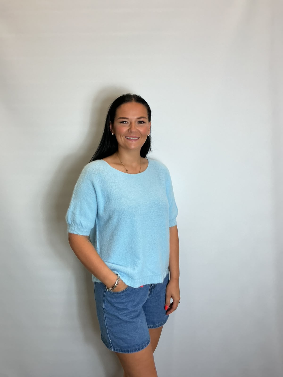 Women’s Light Blue short-sleeve relaxed knit jumper with a wide round neckline and ribbed cuffs and hem.