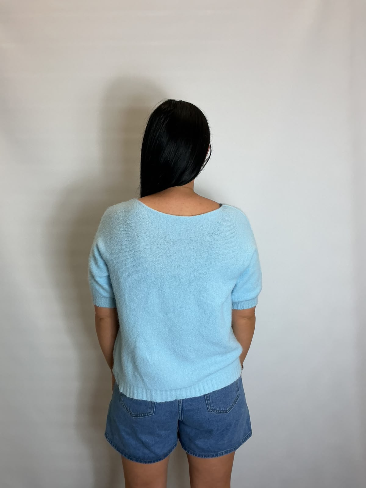 Women’s Light Blue short-sleeve relaxed knit jumper with a wide round neckline and ribbed cuffs and hem.